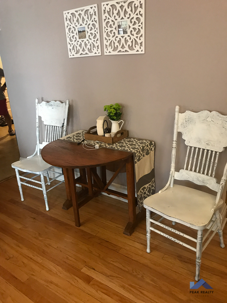 a small dining room with a table and three chairs